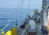 Judi relaxing on deck on passage to Thailand